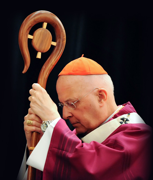 Cardinal George listens to the reading of the Gospel with head bowed while holding his crosier during Mass at the 2011 Chicago Catholic Men's Conference.