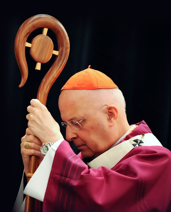 Cardinal George listens to the reading of the Gospel with head bowed while holding his crosier during Mass at the 2011 Chicago Catholic Men's Conference